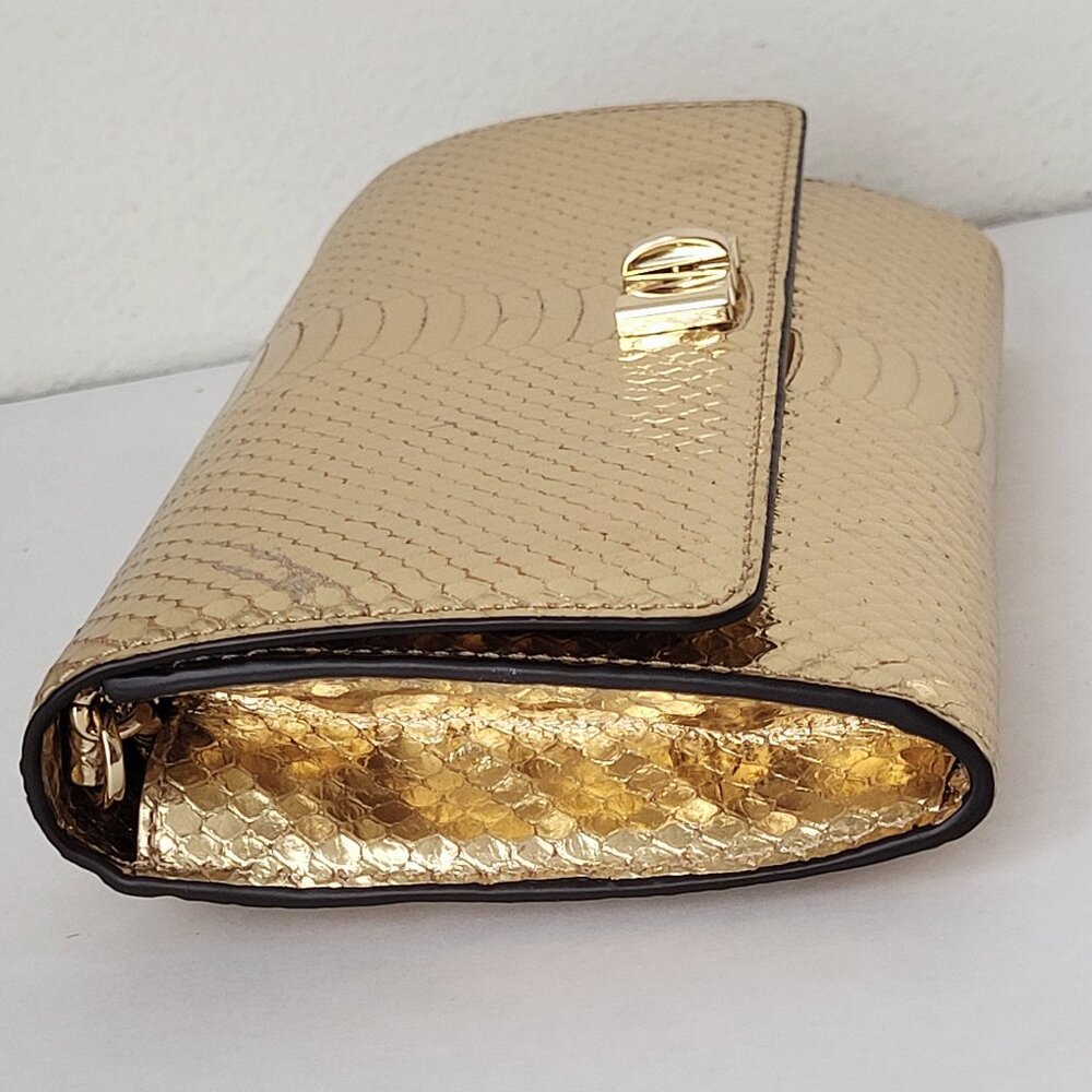 Michael Kors Mott Clutch Crossbody in a metallic gold snake-embossed leather